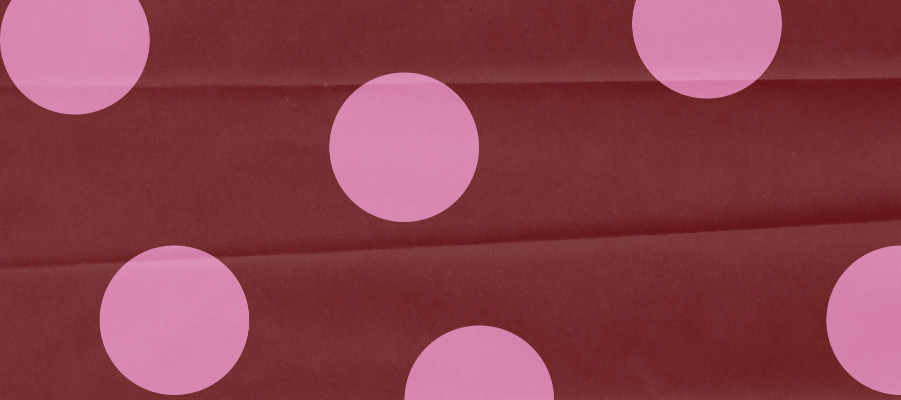 An animation of wrappig paper with polka dots alternating in different colors
