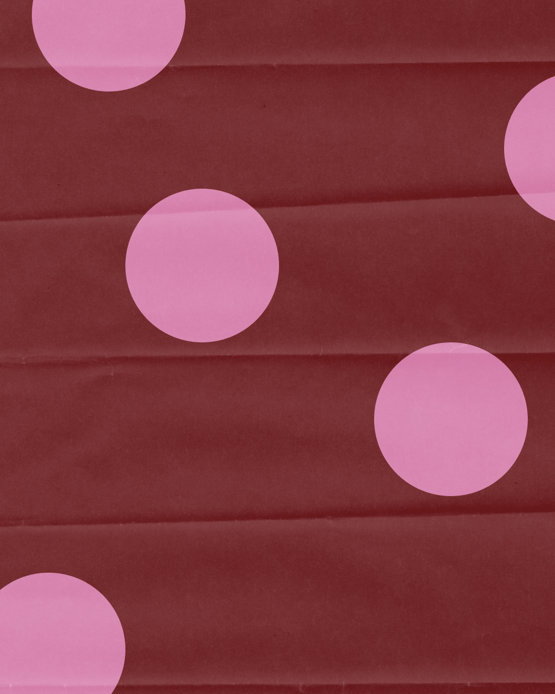 An animation of wrappig paper with polka dots alternating in different colors